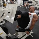 IFBB Pros at Strong and Shapely - Victor Martinez, an IFBB Pro bodybuilder, using a leg press machine at Strong and Shapely Gym.