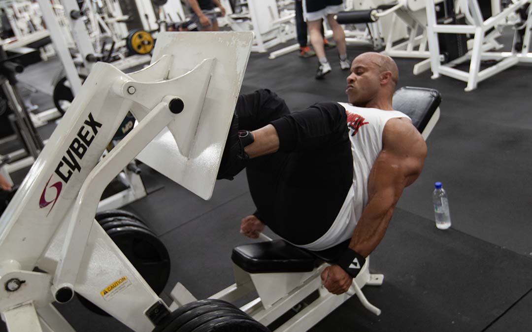 IFBB Pros at Strong and Shapely - Victor Martinez, an IFBB Pro bodybuilder, using a leg press machine at Strong and Shapely Gym.