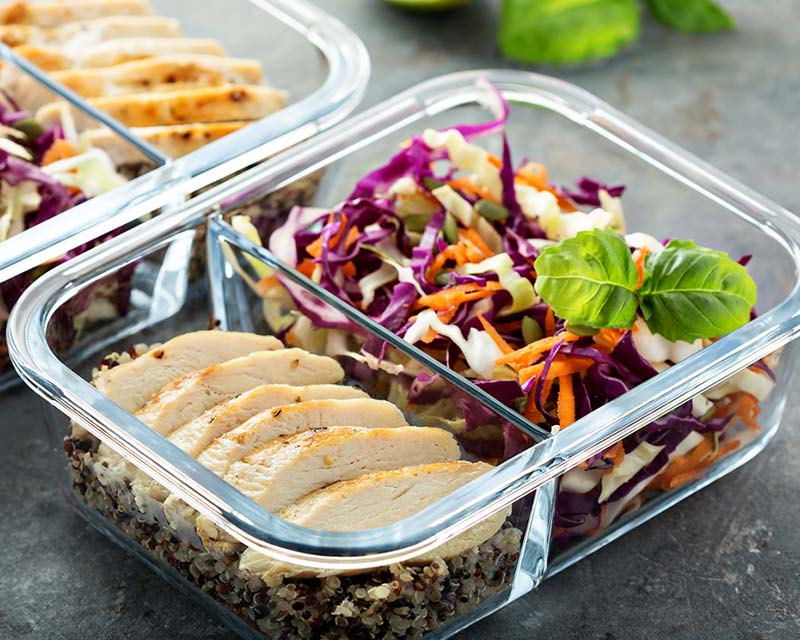 Nutrition Goals in NJ - A meal container filled with a vibrant, balanced salad including fresh greens, colorful vegetables, lean proteins, and healthy fats.